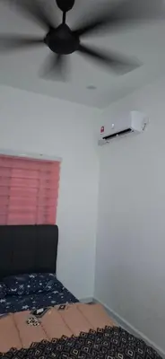 a ceiling fan in a room with a bed at D'Intan Villa Gerik in Gerik