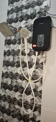 a bathroom with a hair dryer plugged into a wall at D'Intan Villa Gerik in Gerik