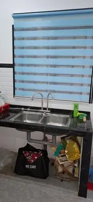 a kitchen counter with a sink and a window at D'Intan Villa Gerik in Gerik