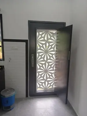 a metal door with a window in a bathroom at D'Intan Villa Gerik in Gerik
