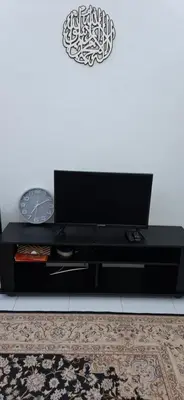 a black entertainment center with a flat screen tv at D'Intan Villa Gerik in Gerik