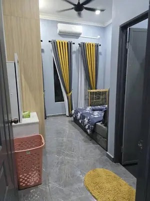 a bedroom with a bed and a ceiling fan at Kak Nah Homestay A Mus'lim Only in Taiping