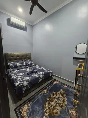 a bedroom with a bed and a ceiling fan at Kak Nah Homestay A Mus'lim Only in Taiping