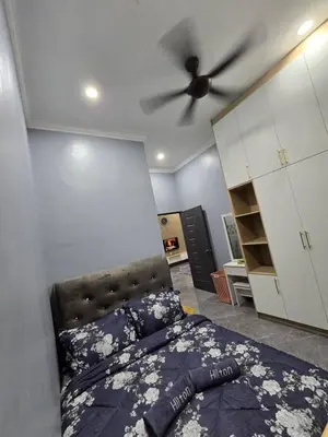 a bedroom with a bed and a ceiling fan at Kak Nah Homestay A Mus'lim Only in Taiping