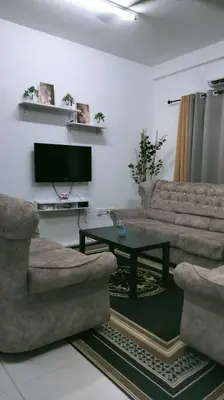 a living room with a couch and a table at KhyraHomestay in Kampong Ayer Melintas Besar