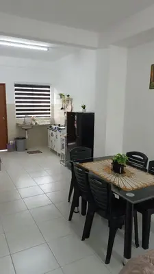 a kitchen and dining room with a table and chairs at KhyraHomestay in Kampong Ayer Melintas Besar