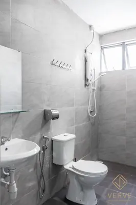 a white bathroom with a toilet and a sink at Fusy Homestay Casa Kayangan Meru B2101 in Ipoh