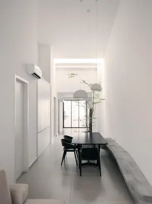 a dining room with a table in a white room at Romantic Rooftop Jacuzzi Villa with Sunset Views in Jelutong