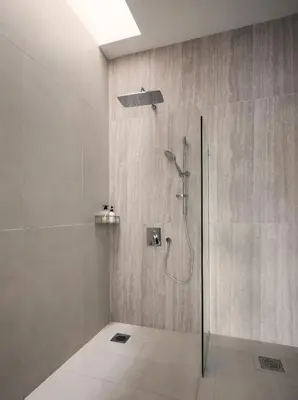 a bathroom with a shower with a glass door at Romantic Rooftop Jacuzzi Villa with Sunset Views in Jelutong