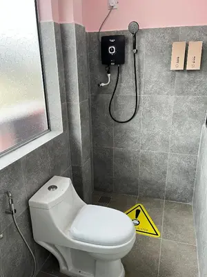 a bathroom with a toilet and a shower at Hippo House Taiping in Taiping