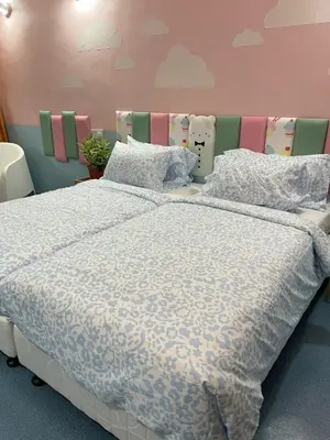 a bedroom with a large bed with pillows at Hippo House Taiping in Taiping