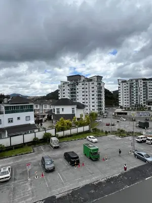a parking lot with parked cars in a city at Wan AyuRa Homestay in Tanah Rata