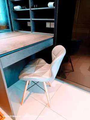 a white chair sitting in front of a counter at Taman Sejati Sitiawan Cumi Home 4BR with pool, BBQ in Sitiawan