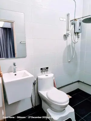 a bathroom with a toilet and a sink at Taman Sejati Sitiawan Cumi Home 4BR with pool, BBQ in Sitiawan