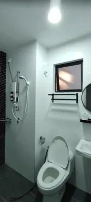 a white bathroom with a toilet and a window at DeRose Homestay, Pekan Ipoh in Ipoh