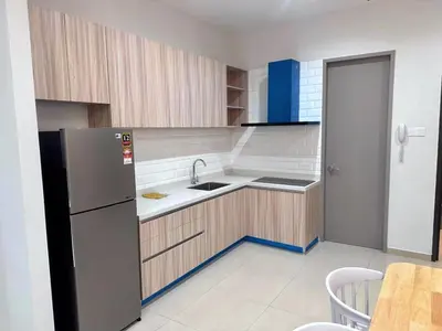a kitchen with a refrigerator and a sink and a table at Wanderlust Retreat in Bayan Lepas