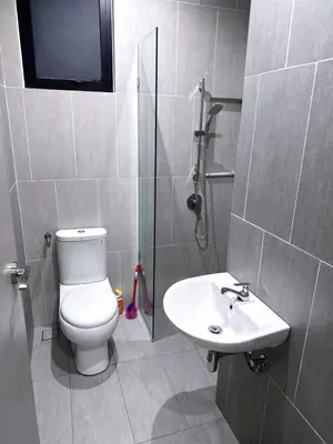 a bathroom with a toilet and a sink at Wanderlust Retreat in Bayan Lepas