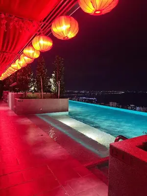 a swimming pool at night with red lights at Wanderlust Retreat in Bayan Lepas