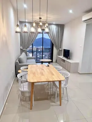 a living room with a table and chairs and a couch at Wanderlust Retreat in Bayan Lepas