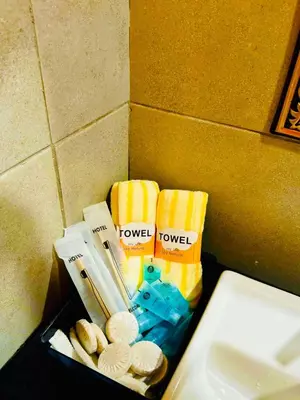 a box of towels on a counter next to a sink at VIP3BR Romantic Retreat for12 withSea & City Views in Jelutong