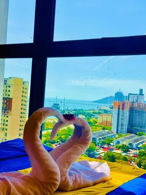 two swans making a heart in front of a window at VIP3BR Romantic Retreat for12 withSea & City Views in Jelutong