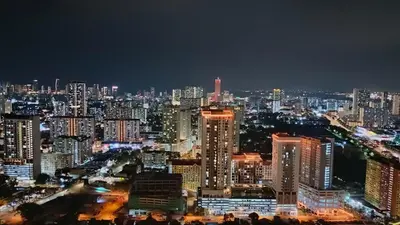 a city skyline at night with lit buildings at VIP3BR Romantic Retreat for12 withSea & City Views in Jelutong
