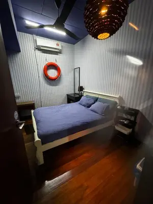 a bedroom with a bed with a blue comforter at VIP3BR Romantic Retreat for12 withSea & City Views in Jelutong