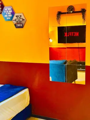 a room with a colorful wall with a mirror at Stunning Sea & City View Apartment in George Town in Jelutong