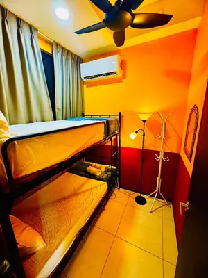 a room with two bunk beds and a ceiling fan at Stunning Sea & City View Apartment in George Town in Jelutong