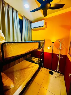 a bedroom with two bunk beds and a ceiling fan at Stunning Sea & City View Apartment in George Town in Jelutong