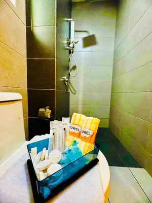 a tray of toiletries sitting on the counter of a bathroom at Spacious3BR 12-PaxApartmentStunning Sea &CityViews in Jelutong