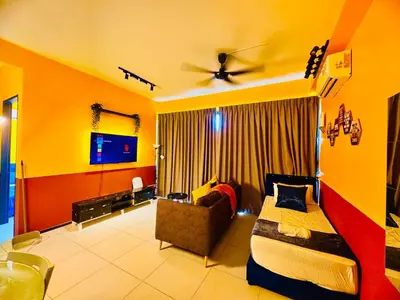 a bedroom with a bed and a couch and a tv at Spacious3BR 12-PaxApartmentStunning Sea &CityViews in Jelutong