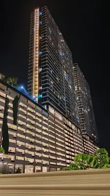 a large building at night with a tall building at Spacious3BR 12-PaxApartmentStunning Sea &CityViews in Jelutong