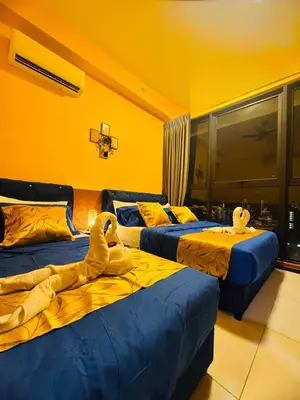 three beds in a room with stuffed animals on them at Deluxe Suites with Infinity Pool, Kids' Pool & Sea in Jelutong