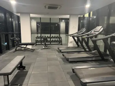 a gym with rows of exercise equipment in a building at Deluxe Suite for10 Stunning Sea &City ViewsNetflix in Jelutong