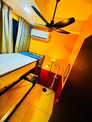 a bedroom with a bed and a ceiling fan at Deluxe Suite for10 Stunning Sea &City ViewsNetflix in Jelutong