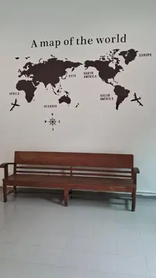 a bench in front of a map of the world at 39 Love Lane - Smart Intelligent Inn Georgetown in George Town