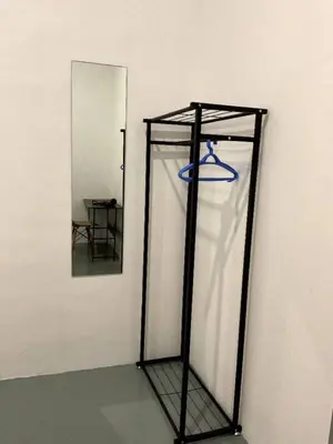a mirror and a shelf with a blue frisbee in it at 39 Love Lane - Smart Intelligent Inn Georgetown in George Town