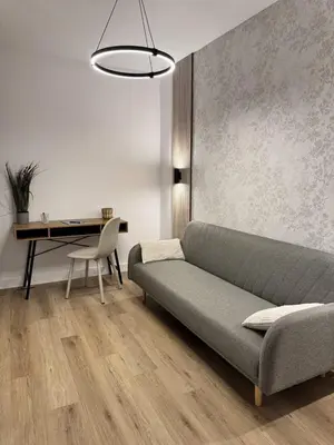 a living room with a couch and a desk at Penginapan Jolra S3 in Sungai Petani