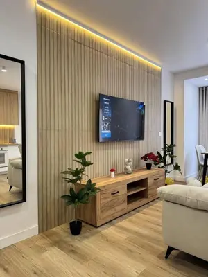a living room with a television on a wall at Penginapan Jolra S3 in Sungai Petani