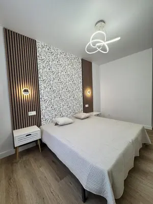 a bedroom with a large bed and a ceiling at Penginapan Jolra S3 in Sungai Petani
