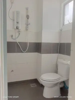 a bathroom with a toilet and a shower at Wan AyuRa Homestay 2 in Tanah Rata