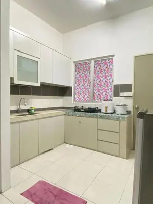 a kitchen with white cabinets and a purple rug at Wan AyuRa Homestay 2 in Tanah Rata