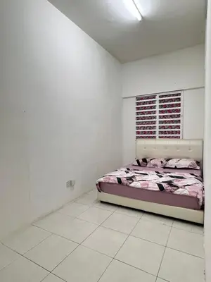 a bedroom with a bed in a white room at Wan AyuRa Homestay 2 in Tanah Rata