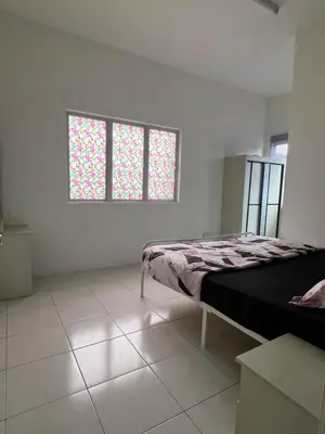 a bedroom with a bed and two windows at Wan AyuRa Homestay 2 in Tanah Rata