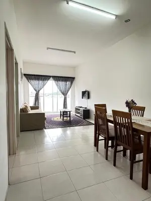 a dining room and living room with a table and chairs at Wan AyuRa Homestay 2 in Tanah Rata