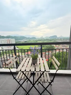 a wooden table with a potted plant on a balcony at The Horizon Retreat in Ipoh