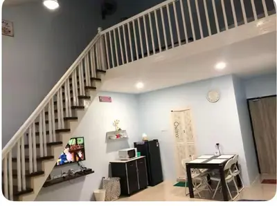 a living room with a staircase in a house at HOME House in George Town