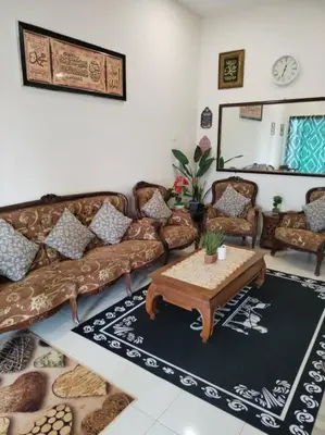 a living room with a couch and a coffee table at A to Z Homestay in Sitiawan