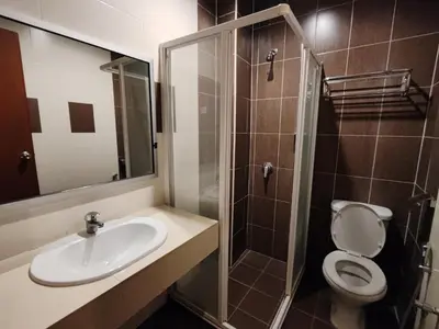 a bathroom with a toilet and a sink and a shower at Iris House Resort & Apartment Cameron Highlands in Cameron Highlands